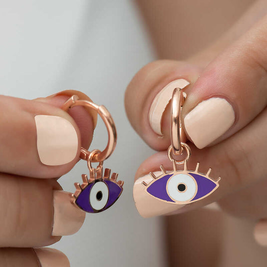 Boucles d'oreilles en argent avec œil violet phosphorescent