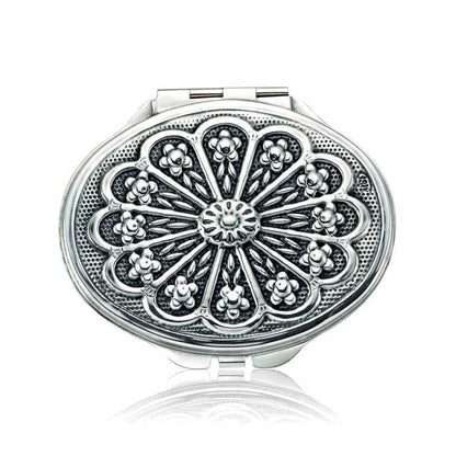 Miroir à main ovale argenté recouvert de motifs de marguerites